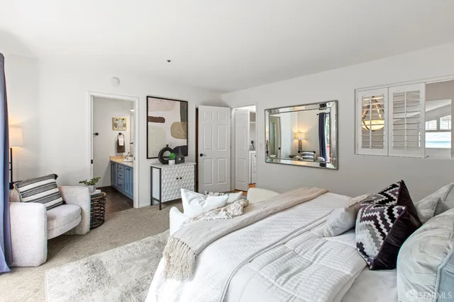 a bedroom with a bed and a mirror