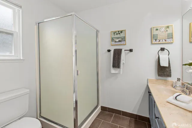 a bedroom with a bed and a large window with the outer view