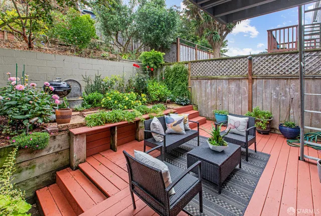 a view of a chairs and table in a backyard