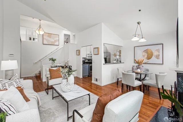 a living room with furniture a rug and a chandelier
