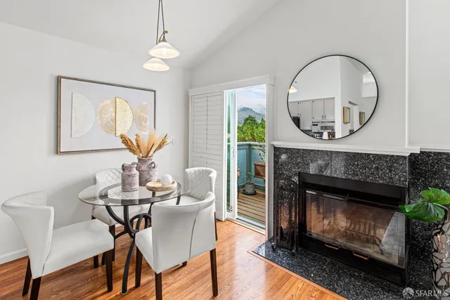 a living room with furniture a mirror and a fireplace