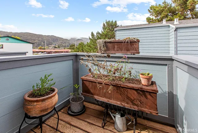a balcony with table and chairs