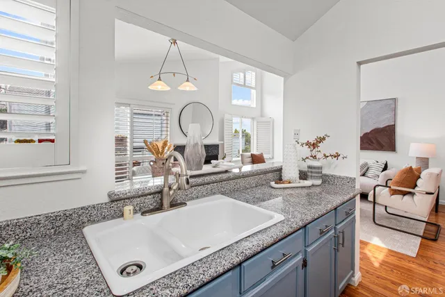 a living room with granite countertop furniture a fireplace and a window