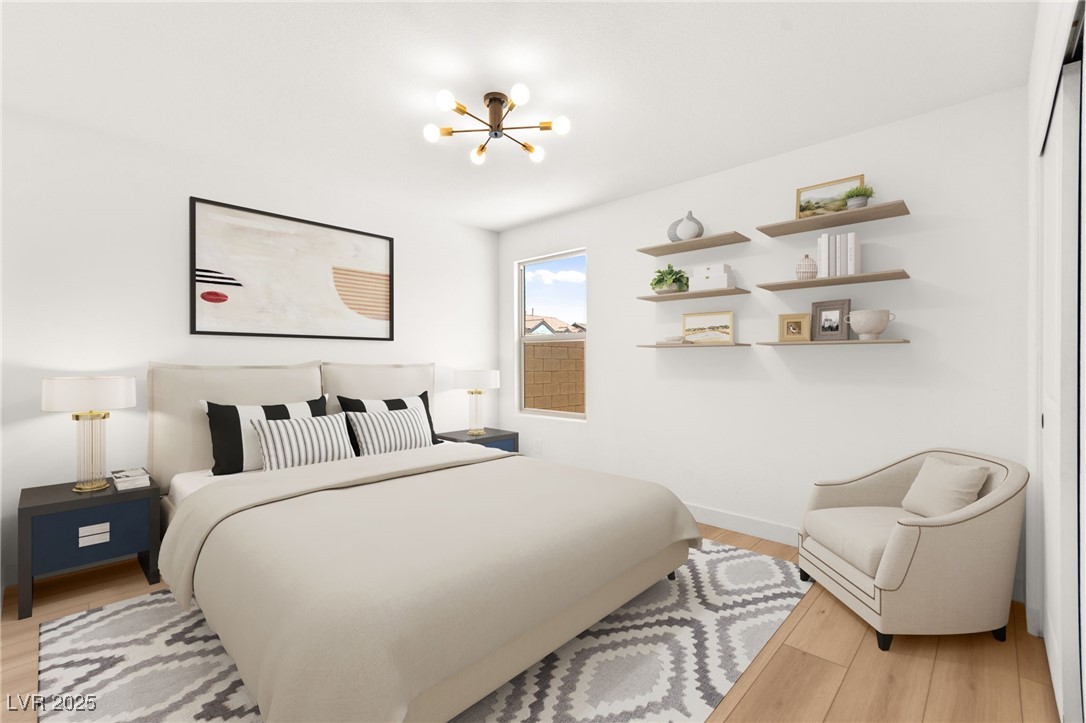 5606 Spring Trellis Street Las Vegas, NV 89113 - Photo 12 of 44 Bedroom with a chandelier and light wood finished floors
