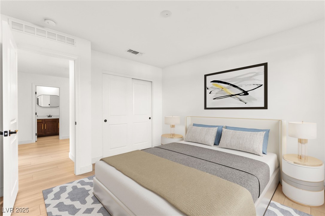 5606 Spring Trellis Street Las Vegas, NV 89113 - Photo 15 of 44 Bedroom with light wood-type flooring and a closet