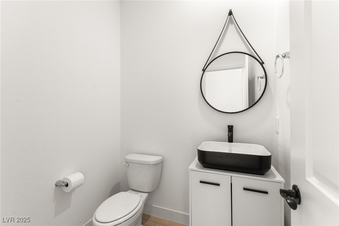 5606 Spring Trellis Street Las Vegas, NV 89113 - Photo 18 of 44 Half bathroom featuring toilet and vanity