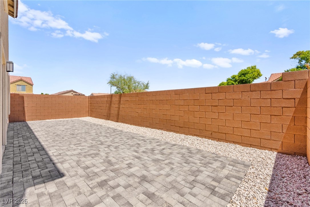 5606 Spring Trellis Street Las Vegas, NV 89113 - Photo 38 of 44 Fenced backyard with a patio