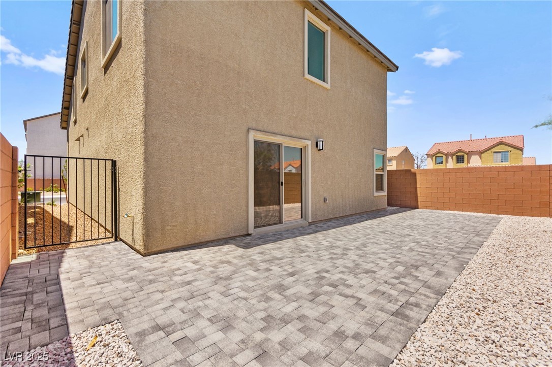 5606 Spring Trellis Street Las Vegas, NV 89113 - Photo 39 of 44 Back of property featuring a fenced backyard, stucco siding, a patio, and a gate