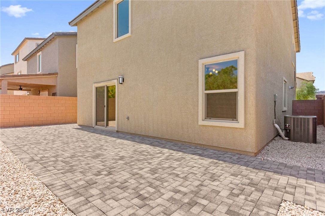 5606 Spring Trellis Street Las Vegas, NV 89113 - Photo 40 of 44 Rear view of property featuring a patio area and stucco siding