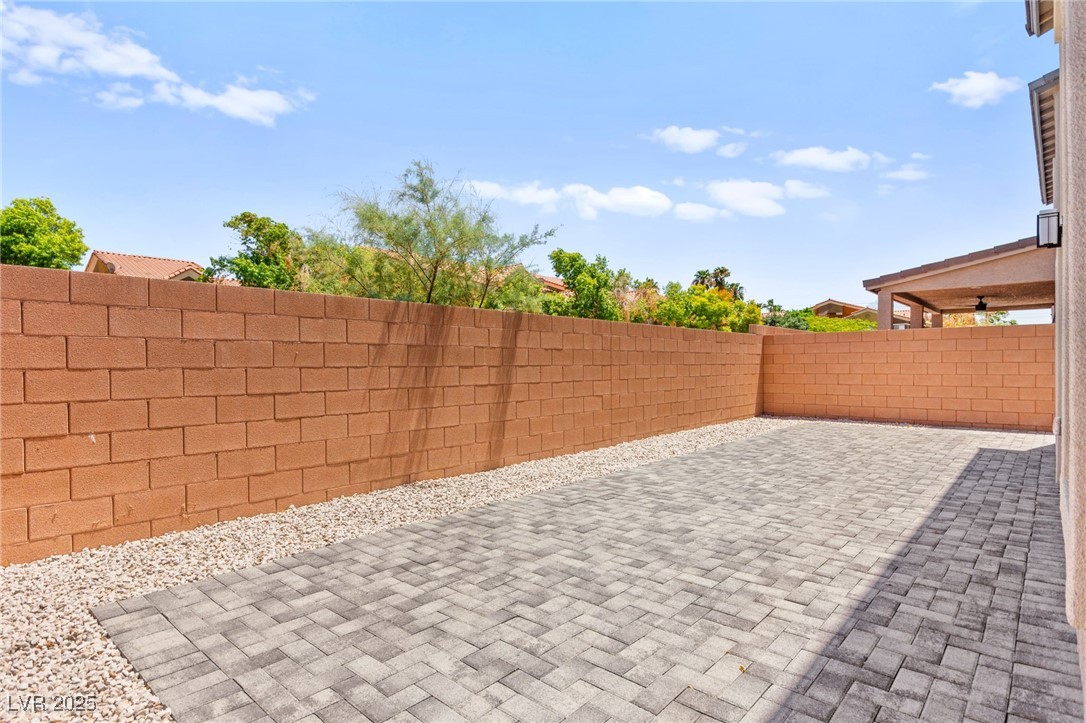 5606 Spring Trellis Street Las Vegas, NV 89113 - Photo 41 of 44 Fenced backyard with a patio area