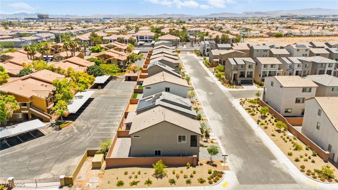 5606 Spring Trellis Street Las Vegas, NV 89113 - Photo 43 of 44 Aerial view of residential area featuring a mountainous background