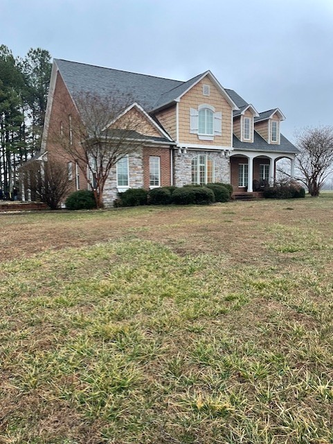 828 Prosser Road Leoma, TN 38468 - Photo 1 of 20 a front view of a house with a garden