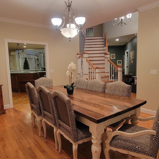 828 Prosser Road Leoma, TN 38468 - Photo 18 of 20 a dining room with wooden floor a chandelier a wooden table and chairs
