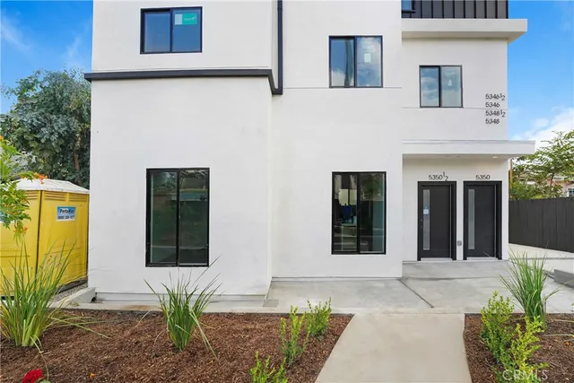 a front view of a house with a outdoor seating space