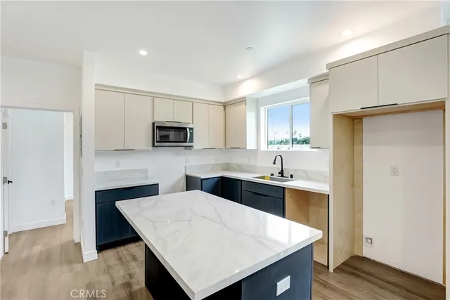 a kitchen with stainless steel appliances sink microwave and cabinets