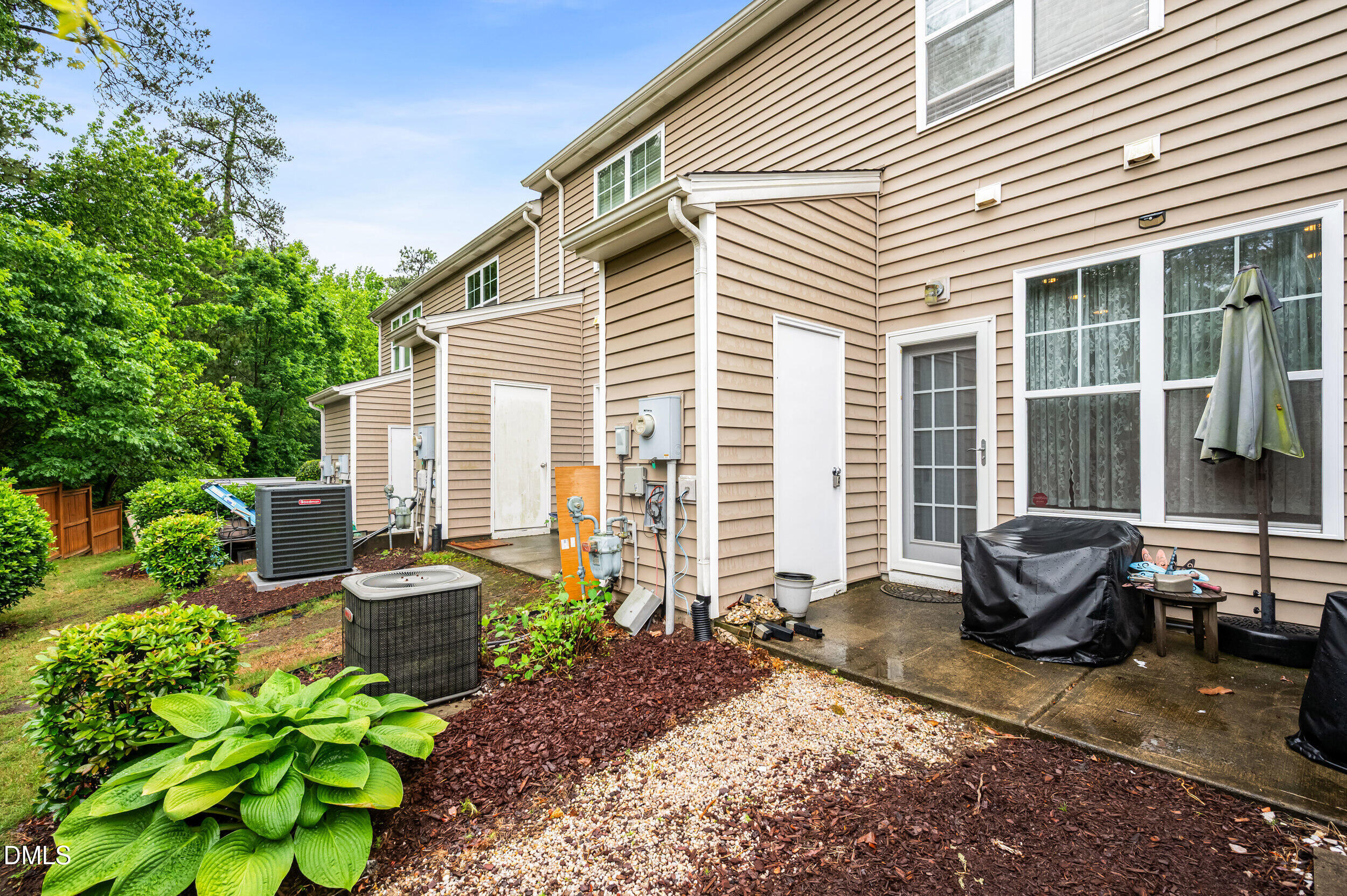 2944 Casona Way Raleigh, NC 27616 - Photo 23 of 24 a backyard with plants and outdoor seating