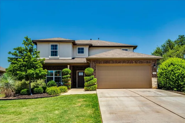 a front view of a house with a yard