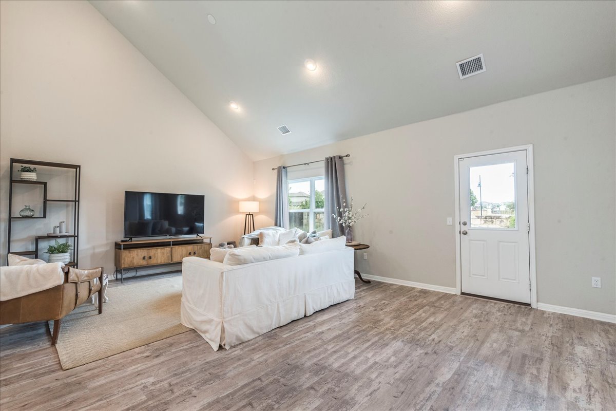 125 Groesbeck Lane Leander, TX 78641 - Photo 11 of 38 a living room with furniture and a flat screen tv