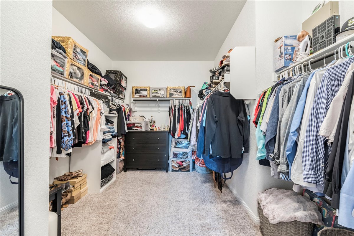 125 Groesbeck Lane Leander, TX 78641 - Photo 19 of 38 a view of walk in closet with clothes
