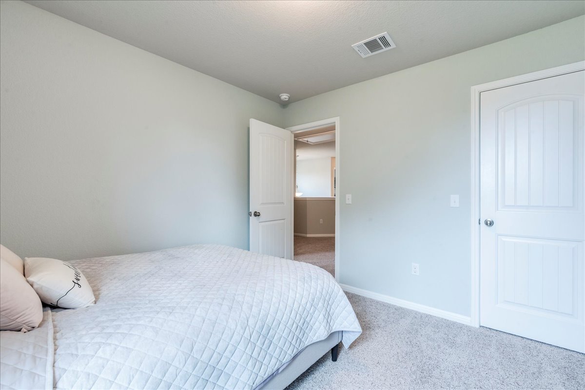 125 Groesbeck Lane Leander, TX 78641 - Photo 24 of 38 a bedroom with a bed and closet