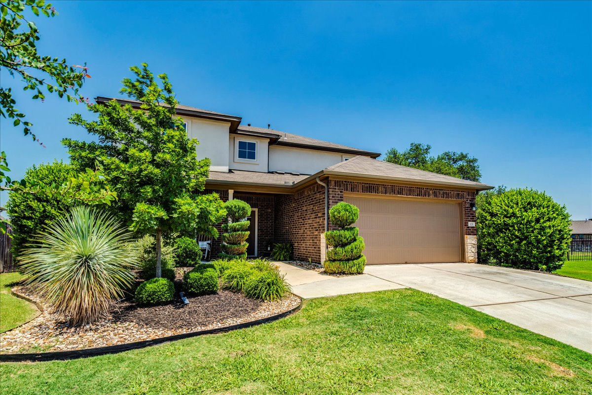 125 Groesbeck Lane Leander, TX 78641 - Photo 3 of 38 a front view of a house with a yard and garage
