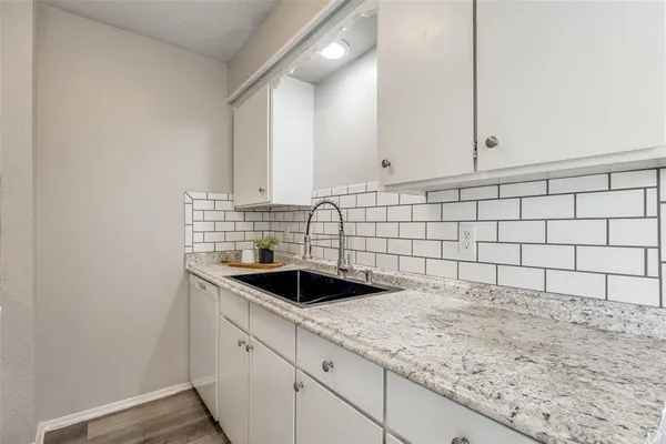 a kitchen with a sink and cabinets