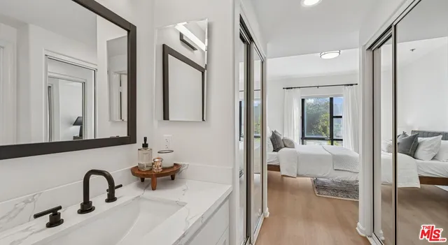 a en suite bathroom with a double vanity sink and a large mirror