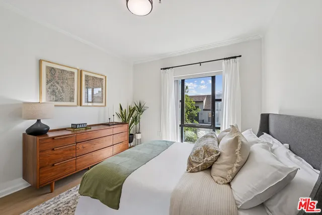 a bedroom with a large bed and a window