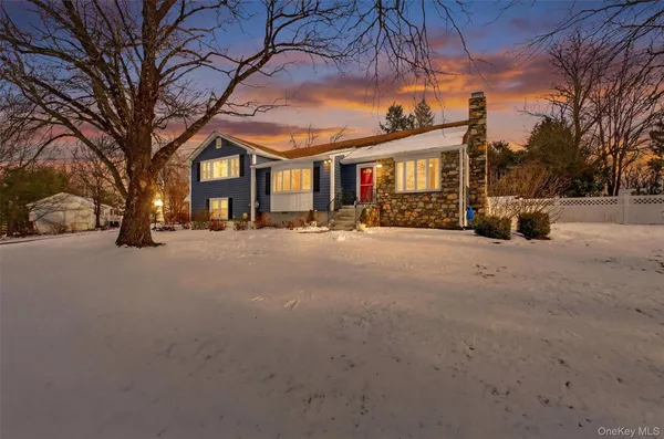 a view of a house with a snow in a yard