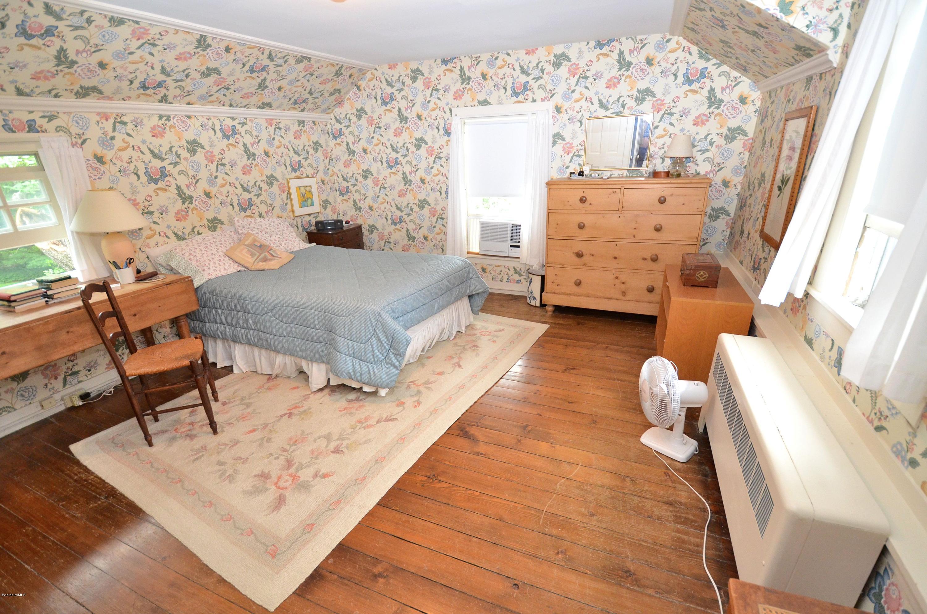 4 Cherry Hill Road Stockbridge, MA 01262 - Photo 14 of 19 a living room with a baby crib furniture and a dresser
