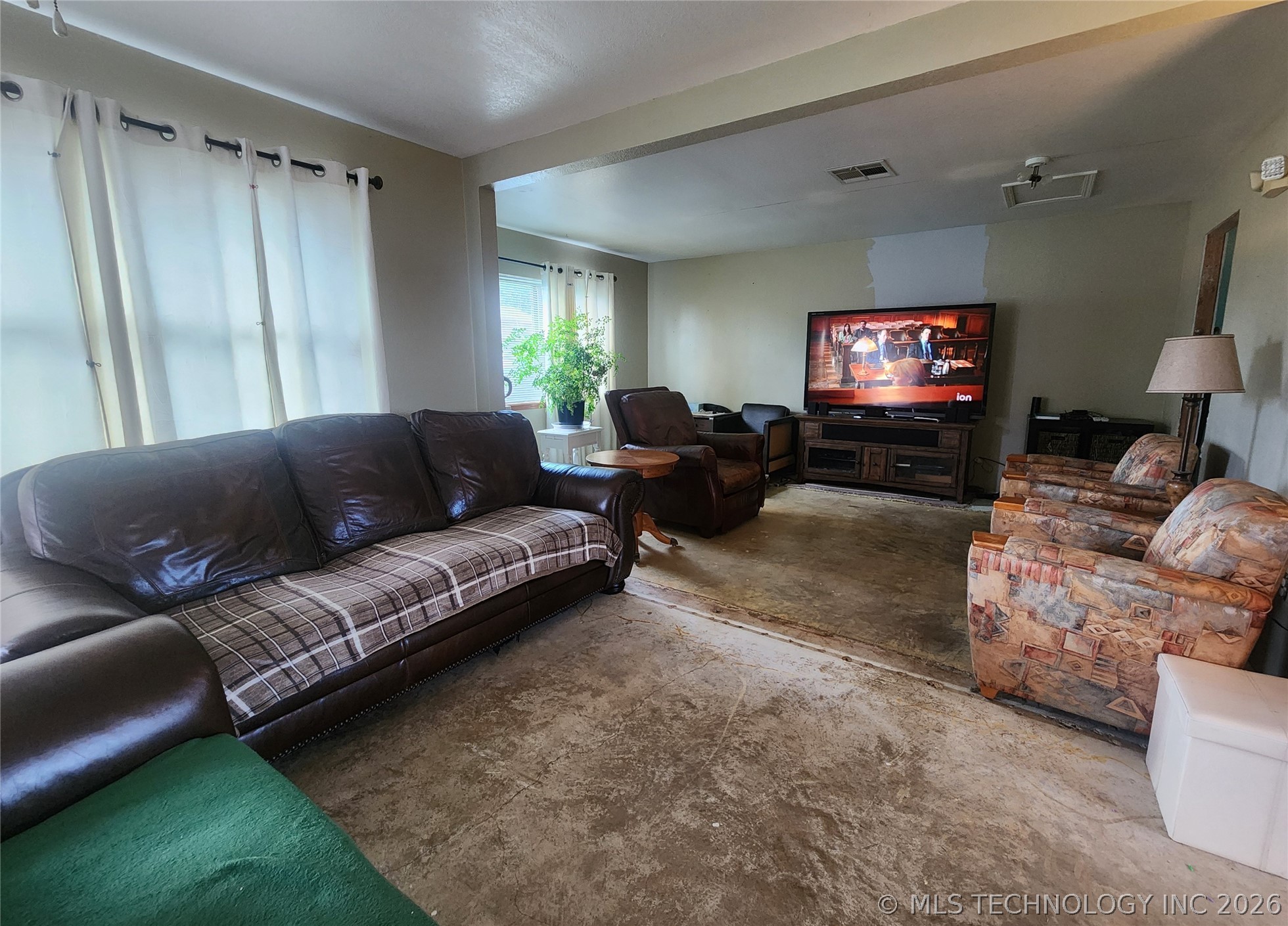 149 West Ruth Atoka, OK 74525 - Photo 16 of 62 Open concept living space with warm toned walls and natural light