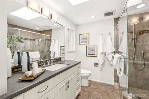 a bathroom with a double vanity sink a mirror and a shower