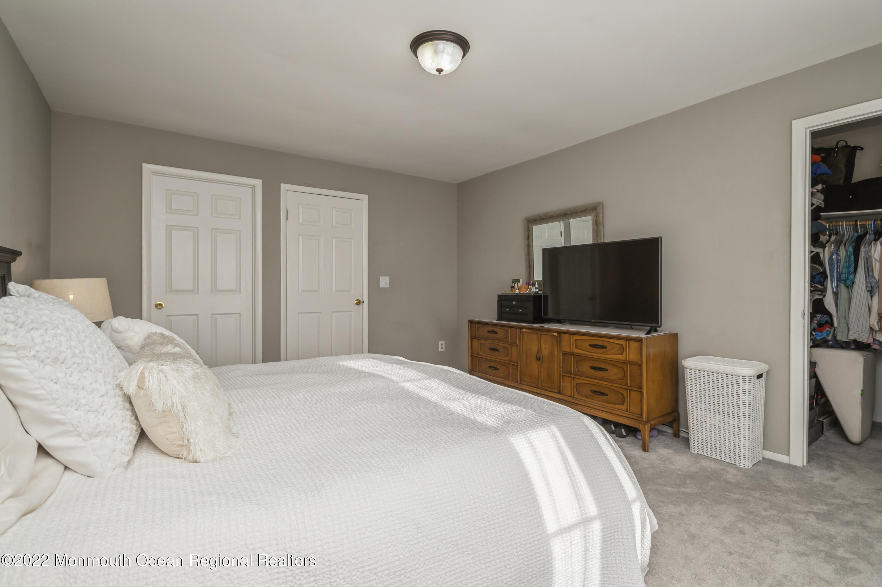503 Harding Road, Unit 5 Freehold, NJ 07728 - Photo 15 of 21 a bedroom with a bed and a flat screen tv