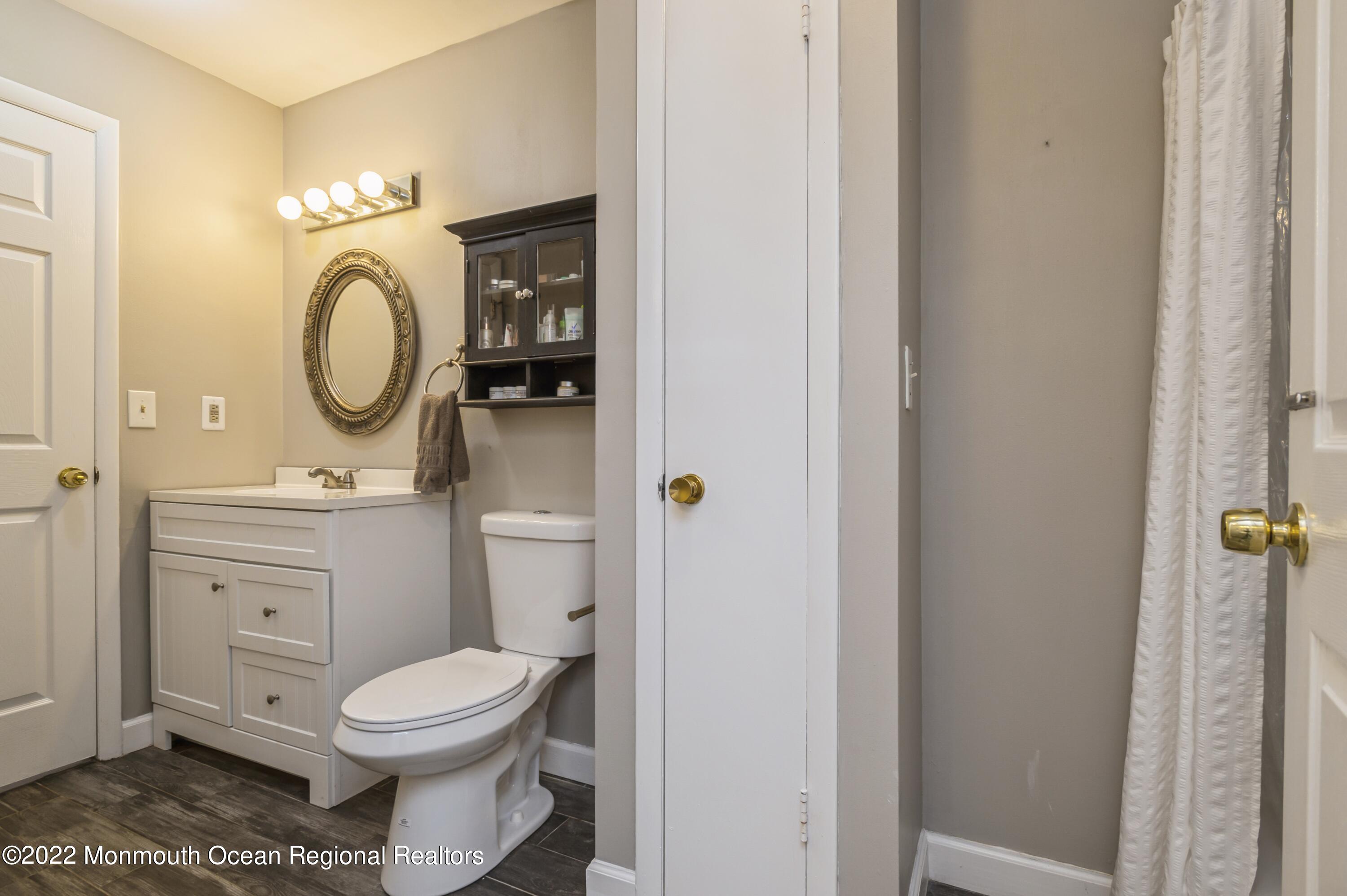 503 Harding Road, Unit 5 Freehold, NJ 07728 - Photo 18 of 21 a bathroom with a toilet a sink and a mirror