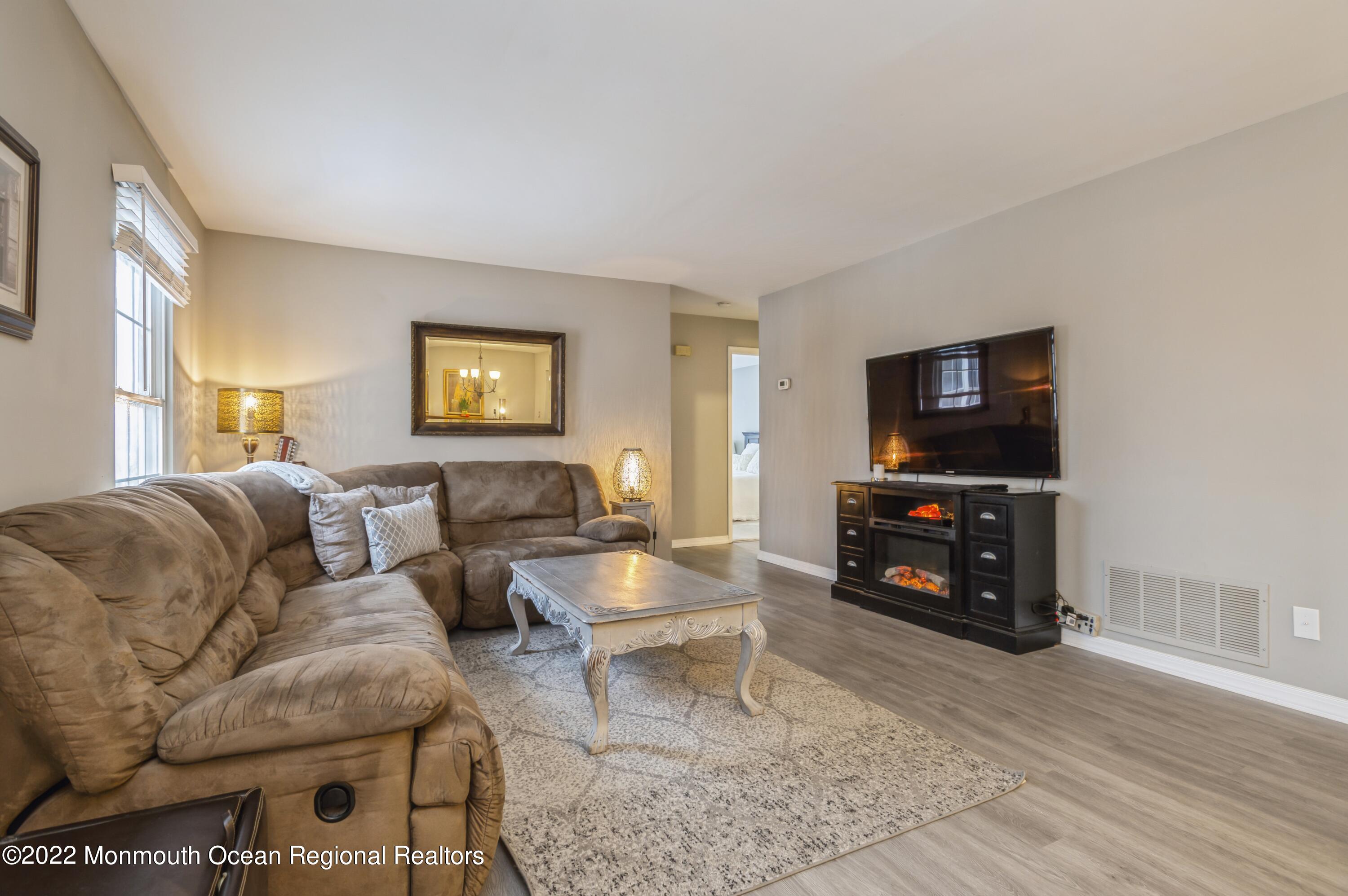 503 Harding Road, Unit 5 Freehold, NJ 07728 - Photo 2 of 21 a living room with furniture and a flat screen tv