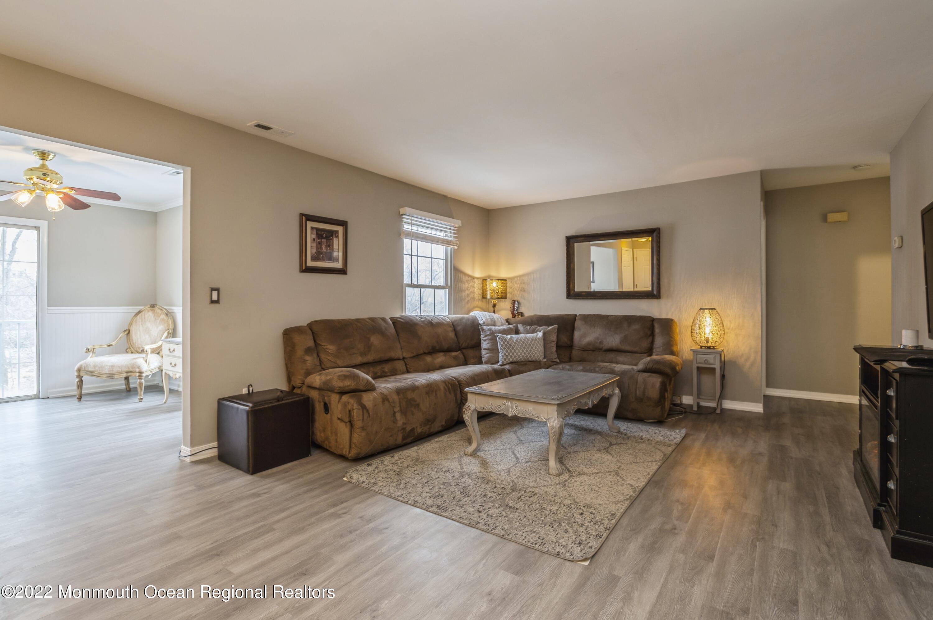 503 Harding Road, Unit 5 Freehold, NJ 07728 - Photo 3 of 21 a living room with furniture and a wooden floor