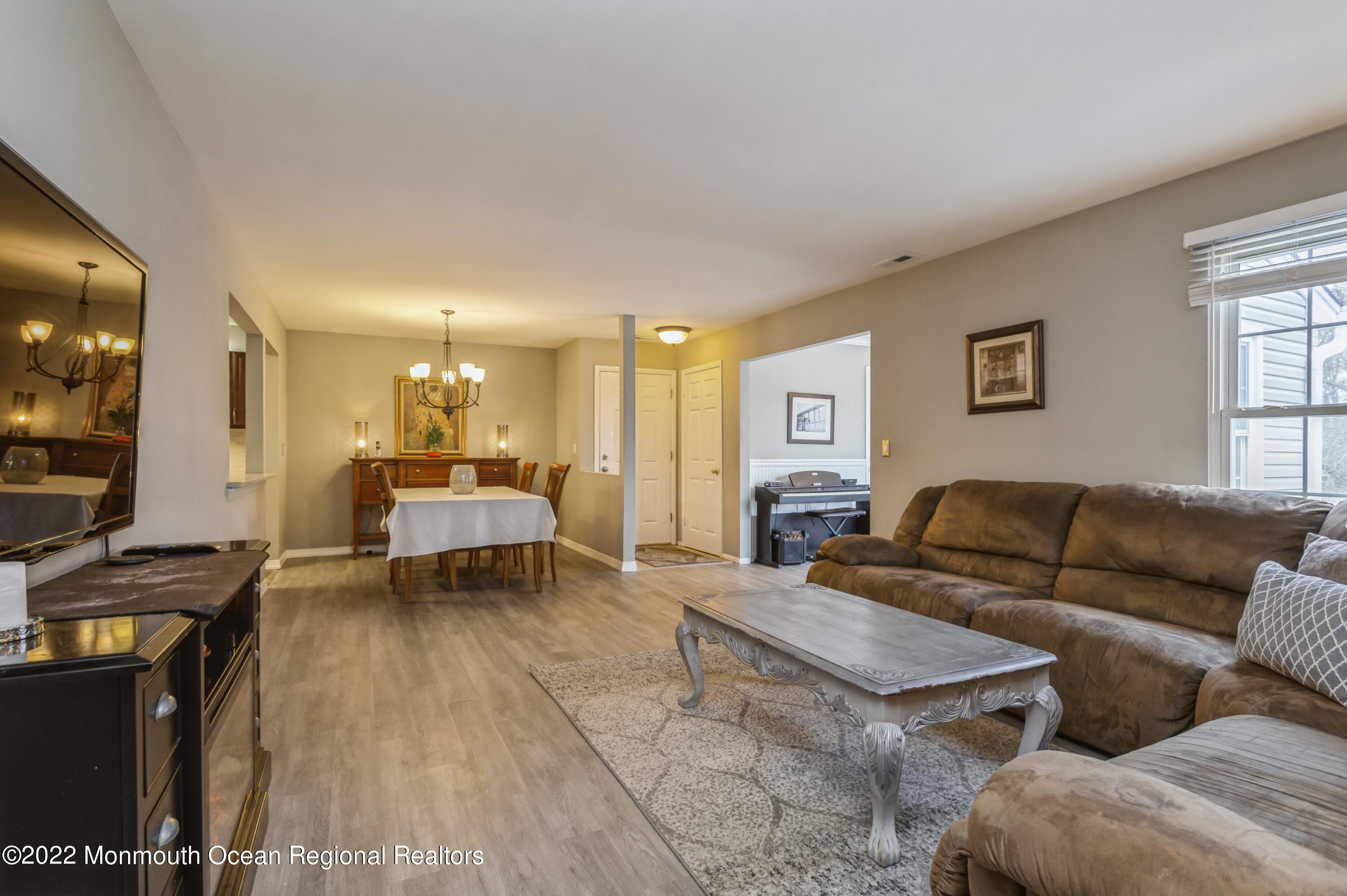 503 Harding Road, Unit 5 Freehold, NJ 07728 - Photo 4 of 21 a living room with furniture and a flat screen tv