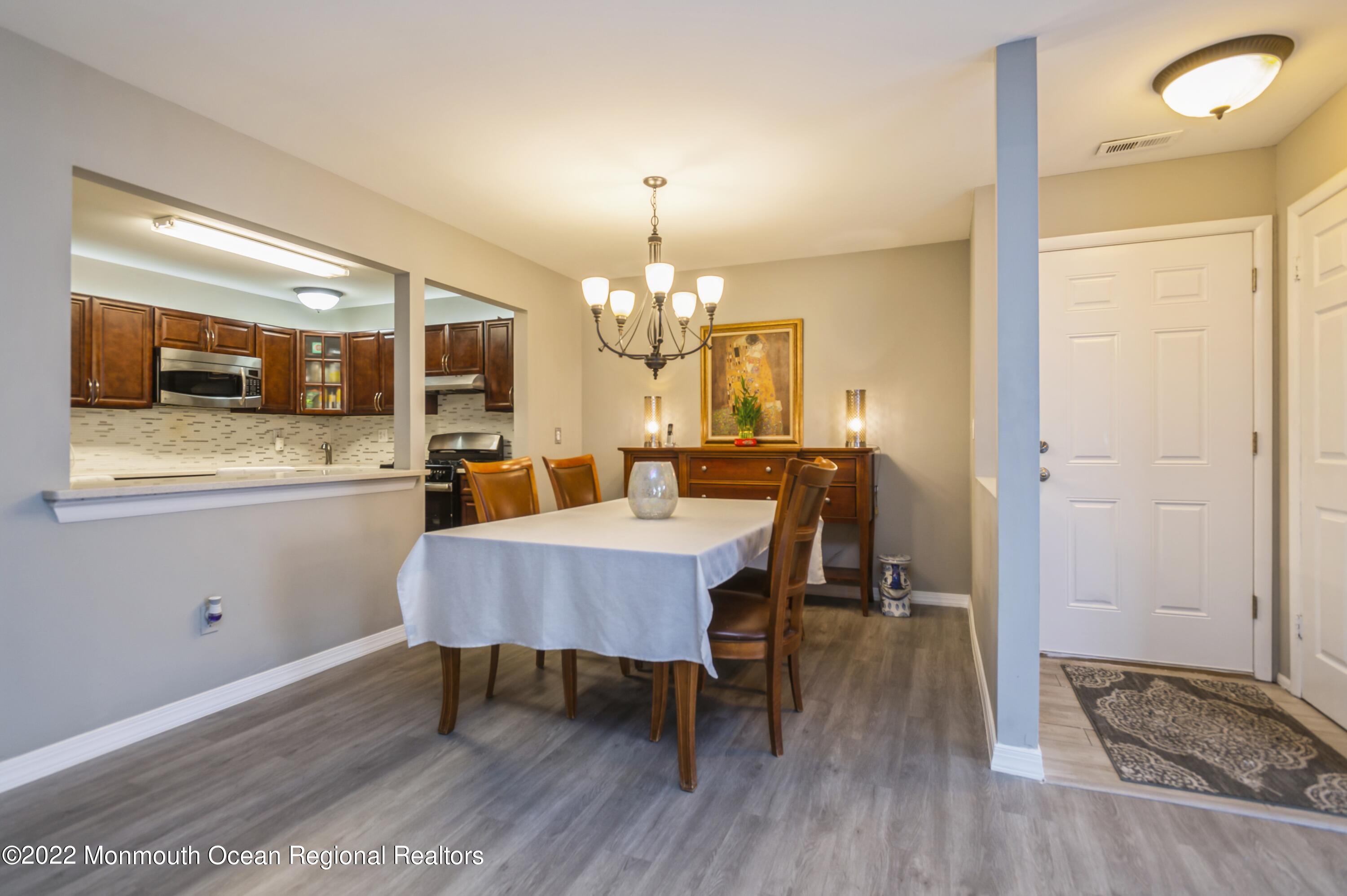 503 Harding Road, Unit 5 Freehold, NJ 07728 - Photo 9 of 21 a view of a dining room with furniture and wooden floor