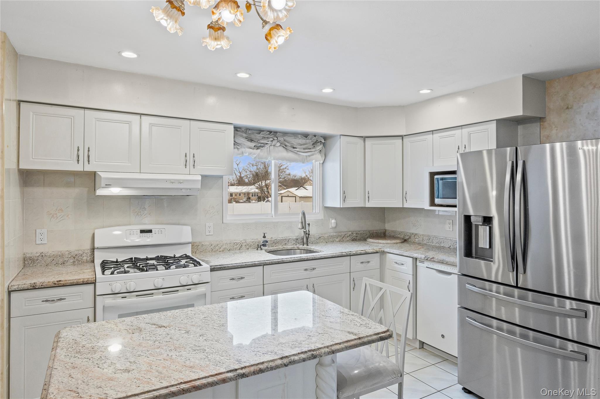 3 Brenner Road Coram, NY 11727 - Photo 11 of 41 a kitchen with white cabinets and stainless steel appliances