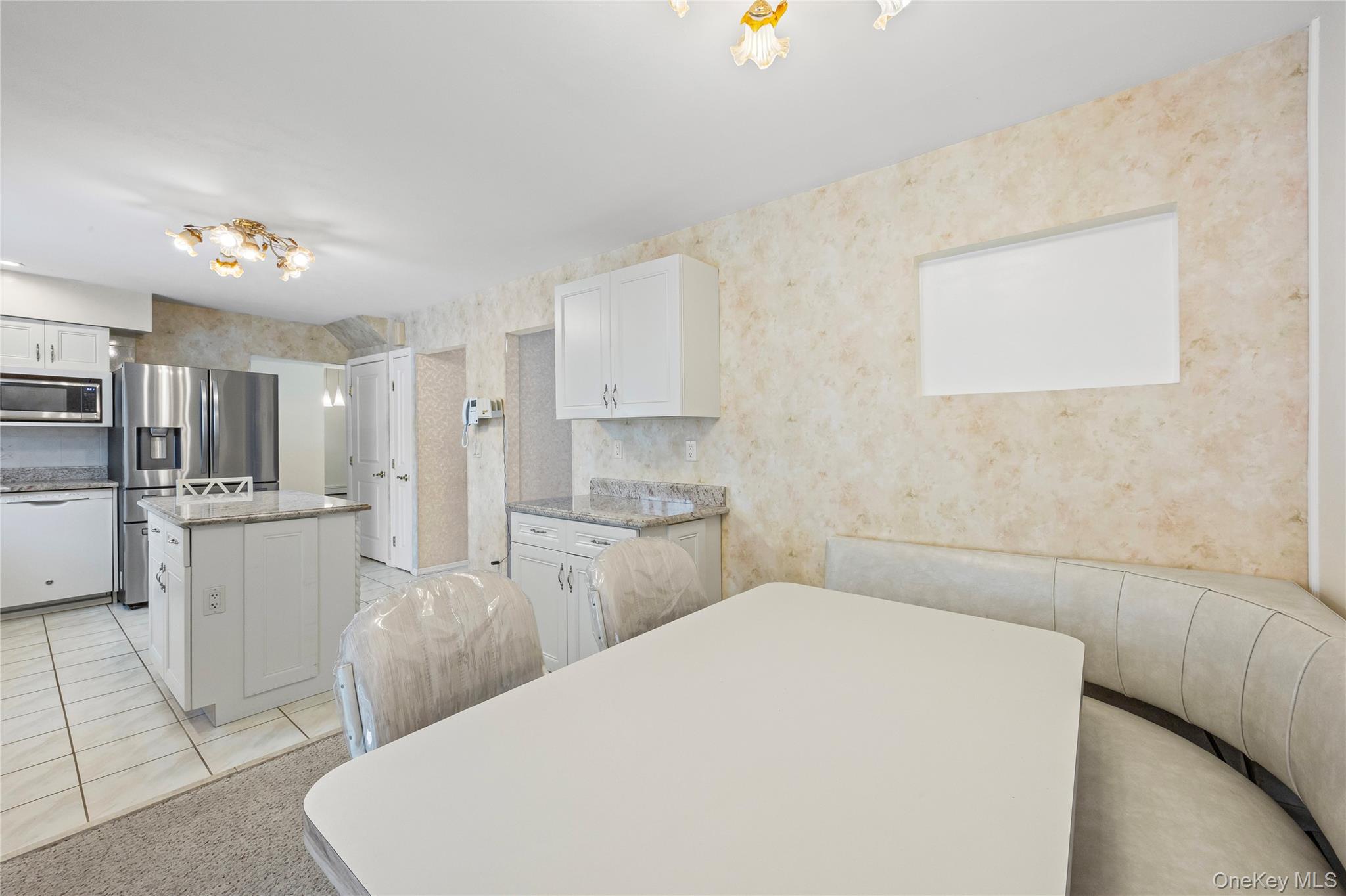 3 Brenner Road Coram, NY 11727 - Photo 14 of 41 a kitchen with white cabinets and stainless steel appliances