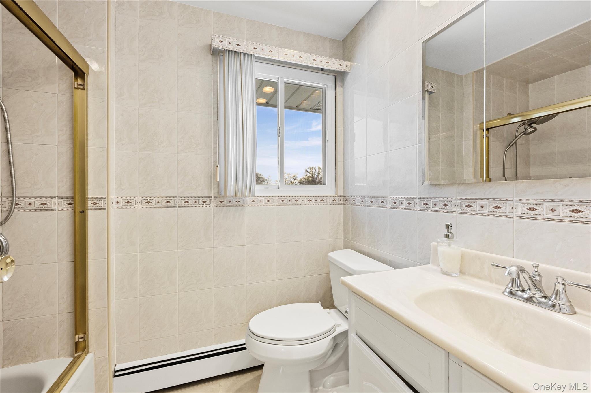 3 Brenner Road Coram, NY 11727 - Photo 27 of 41 a bathroom with a granite countertop sink toilet and a mirror