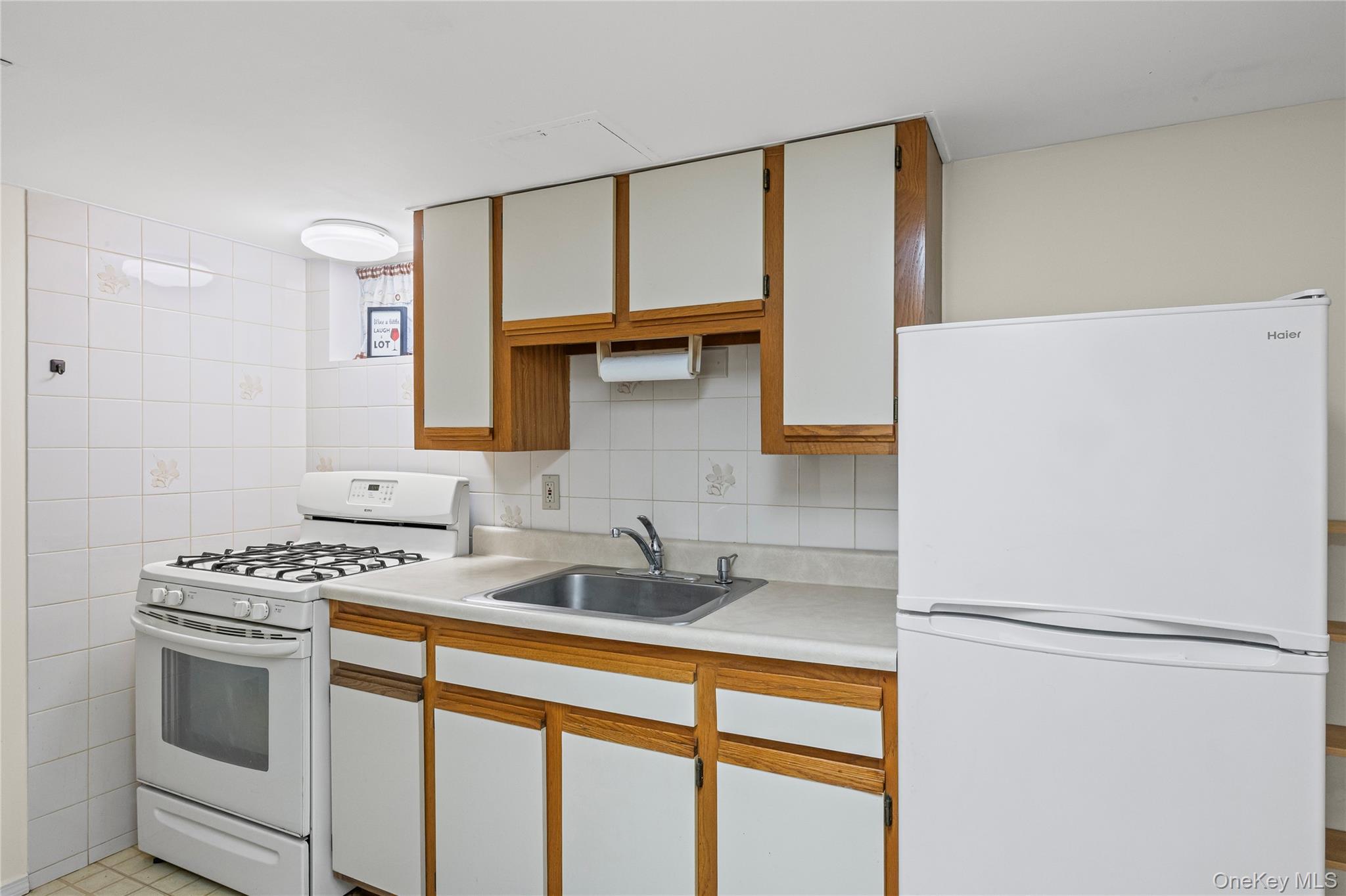 3 Brenner Road Coram, NY 11727 - Photo 34 of 41 a white refrigerator freezer sitting inside of a kitchen