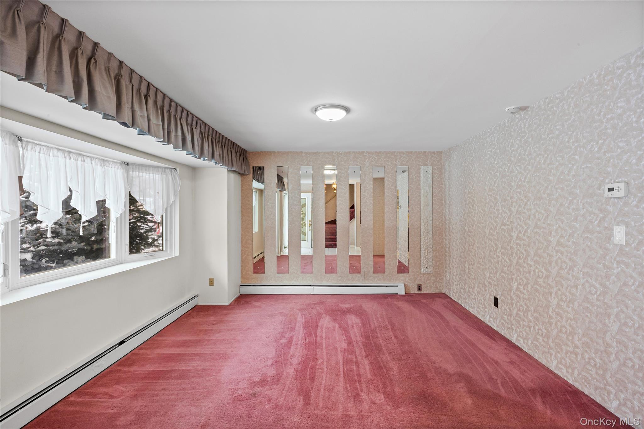 3 Brenner Road Coram, NY 11727 - Photo 9 of 41 a view of a hallway with wooden floor and a window