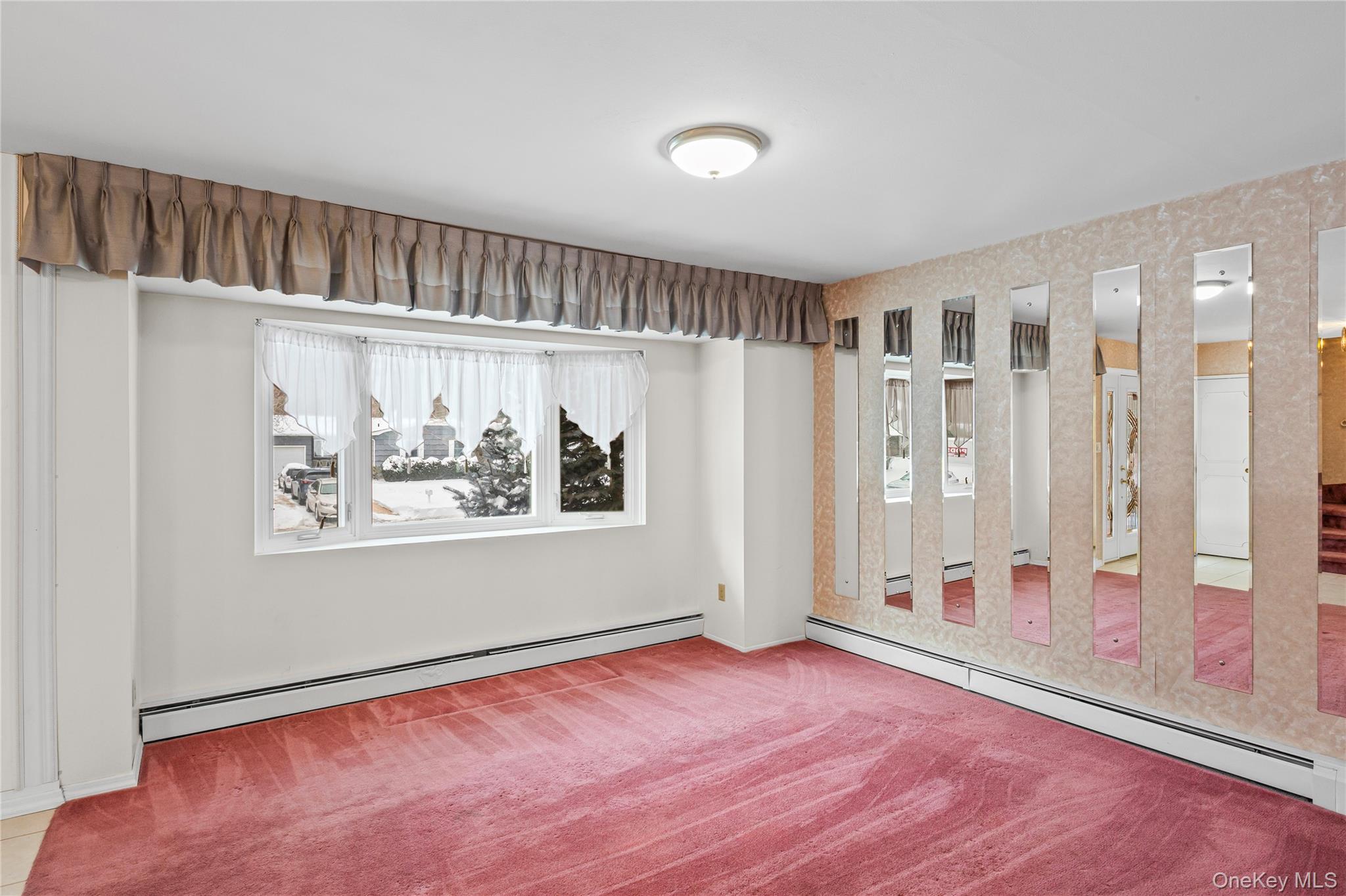 3 Brenner Road Coram, NY 11727 - Photo 10 of 41 a view of an empty room with window and wooden floor