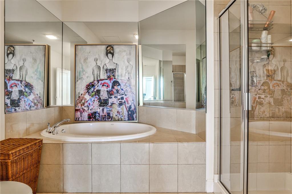 325 East Paces Ferry Road Northeast, Unit 1105 Atlanta, GA 30305 - Photo 14 of 36 a bathroom with a bathtub and shower