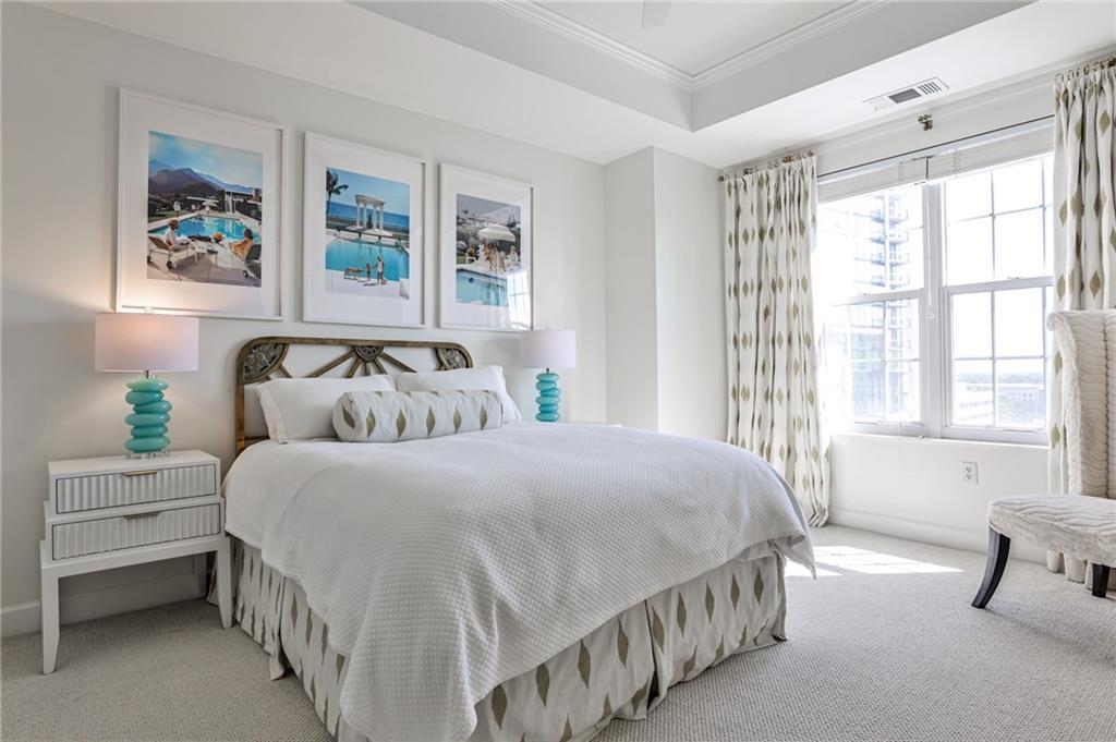 325 East Paces Ferry Road Northeast, Unit 1105 Atlanta, GA 30305 - Photo 16 of 36 a bedroom with double bed and a window