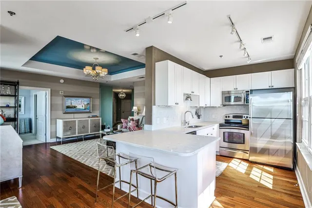 a kitchen with stainless steel appliances granite countertop a stove refrigerator and cabinets
