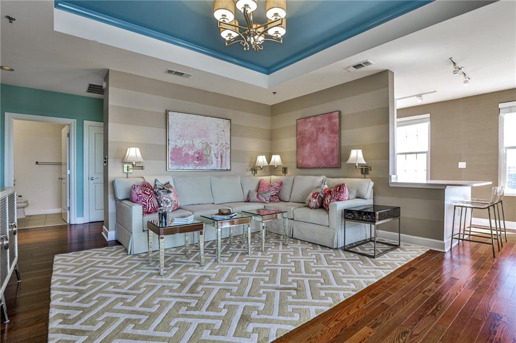325 East Paces Ferry Road Northeast, Unit 1105 Atlanta, GA 30305 - Photo 19 of 36 a living room with furniture and a wooden floor