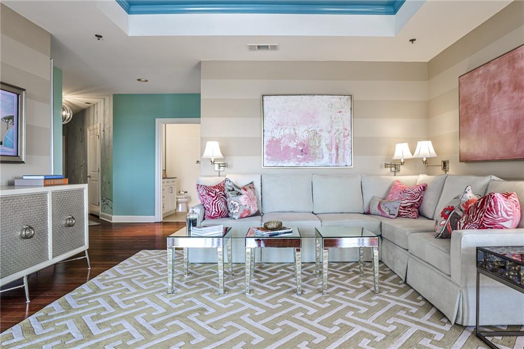 325 East Paces Ferry Road Northeast, Unit 1105 Atlanta, GA 30305 - Photo 2 of 36 a living room with furniture and a dresser