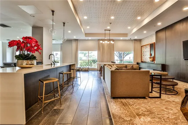 a living room with furniture and a kitchen